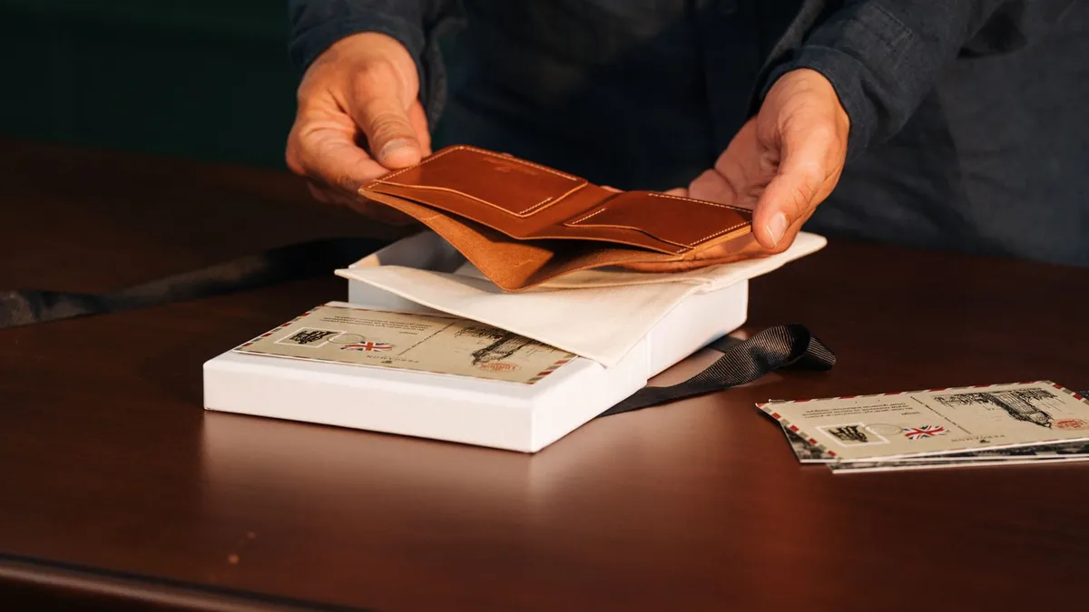 A person sorting letters and envelopes at a home office desk